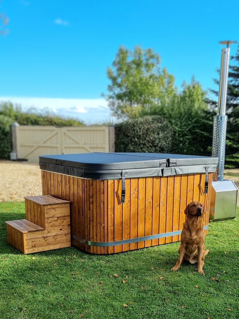 Our 8 seat square-style wood-fired hot tub at our showroom in the Cotswolds, Oxfordshire